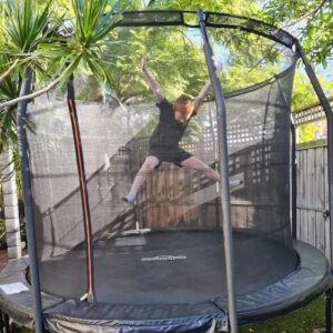 A Boy Jumping in Trampoline